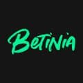 The word Betinia is written in bold, green, cursive-style letters on a black background.